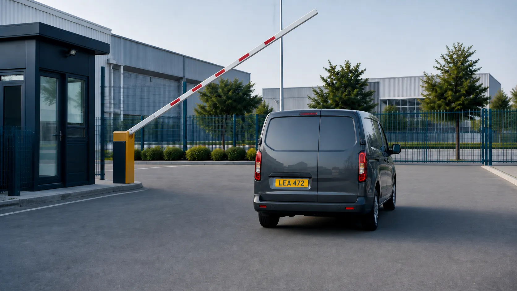 Vehicle entering a factory gate with a visible fictional number plate